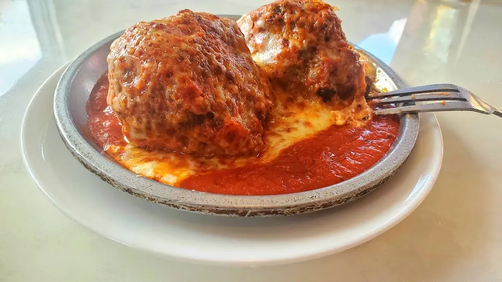 Stuffed Meatball over Some Ricotta Cheese Covered with Mozzarella Cheese